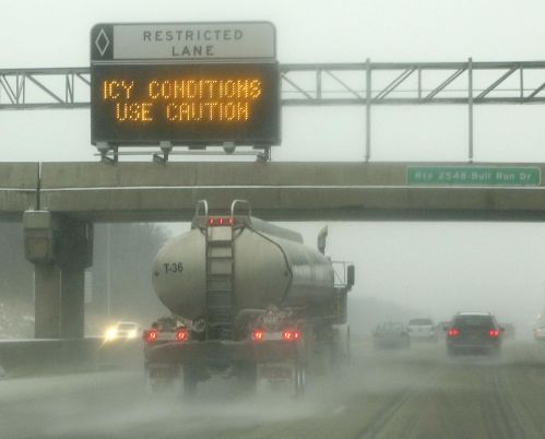 Tanker truck throws icy road spray on Interstate 66 in Manassas, Virginia