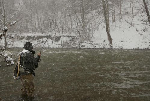 A fly fisherman fishes in blizzard conditions on the Potomac River during a storm in Hopeville Canyon
